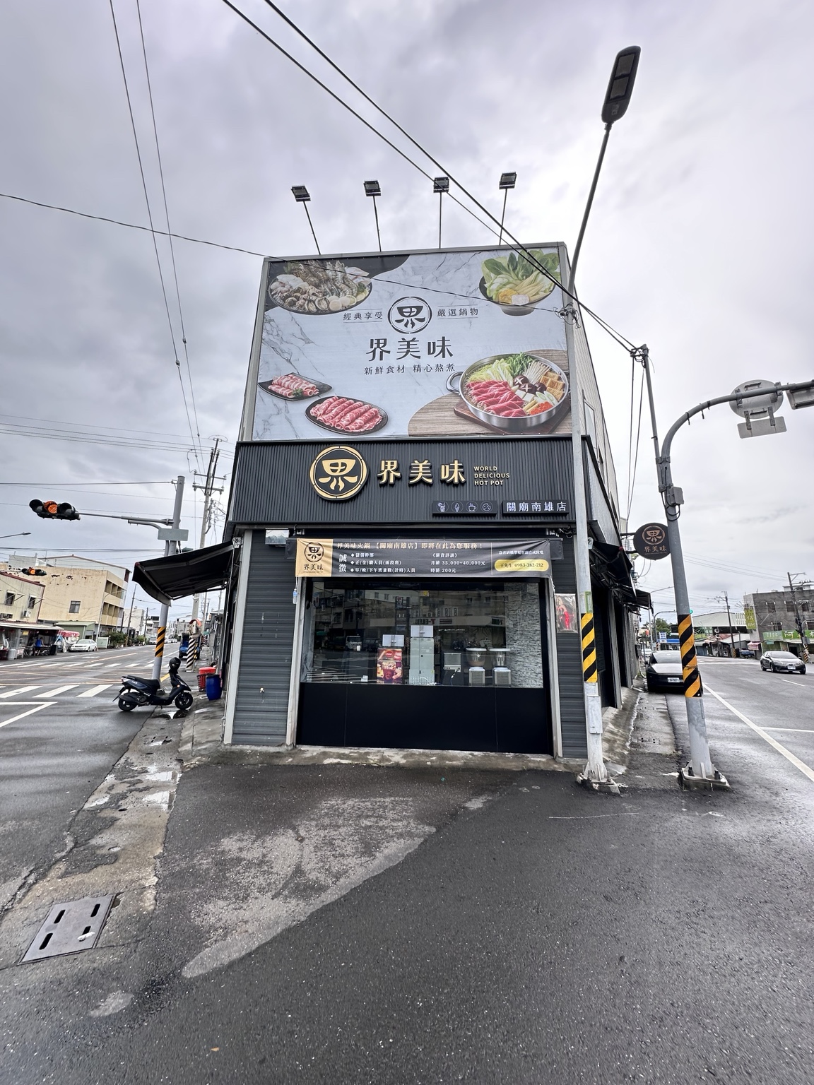 界美味關廟南雄店白天正面，深色企口板、金色外觀立體字及上方帆布